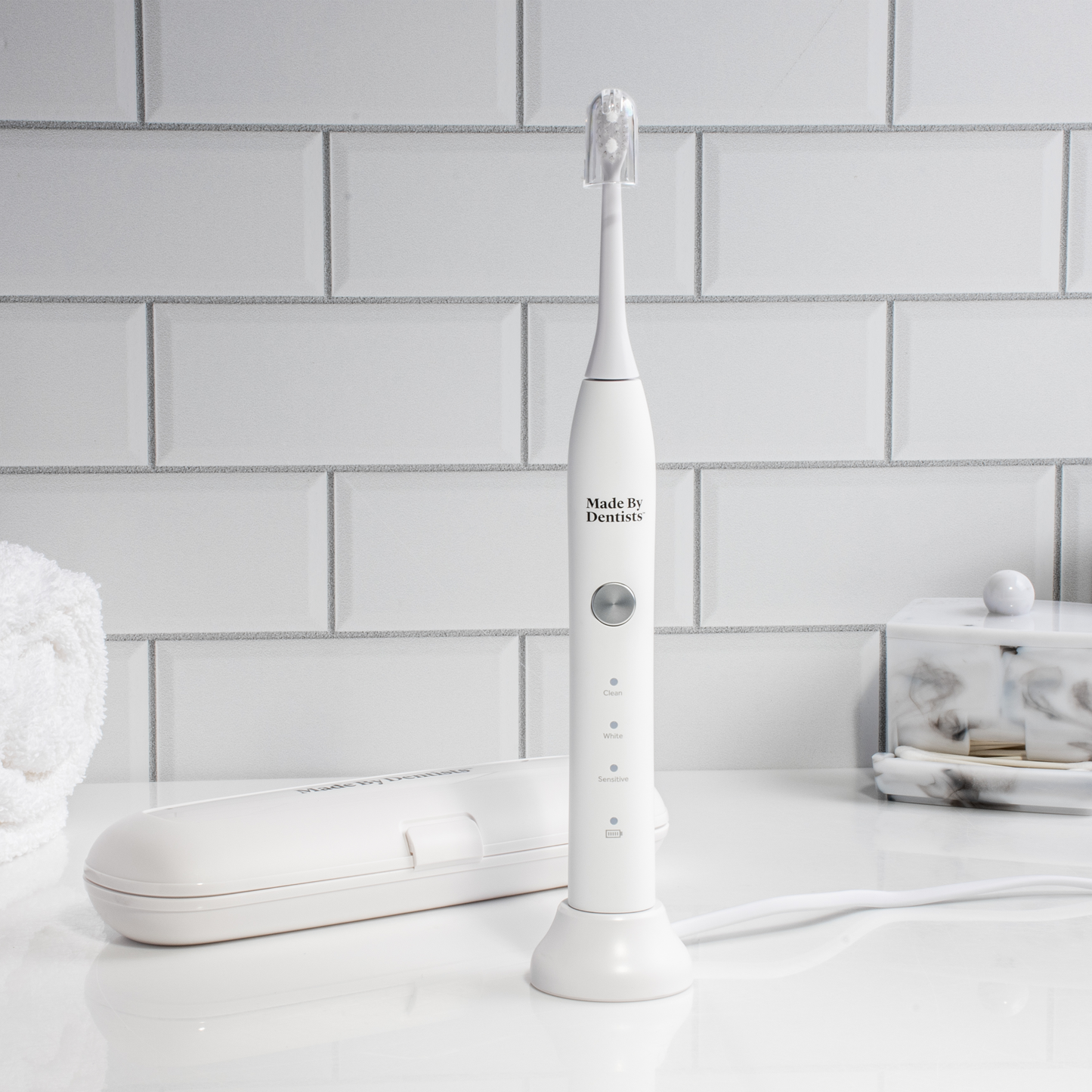 White Sonic Toothbrush with its travel case on a bathroom counter
