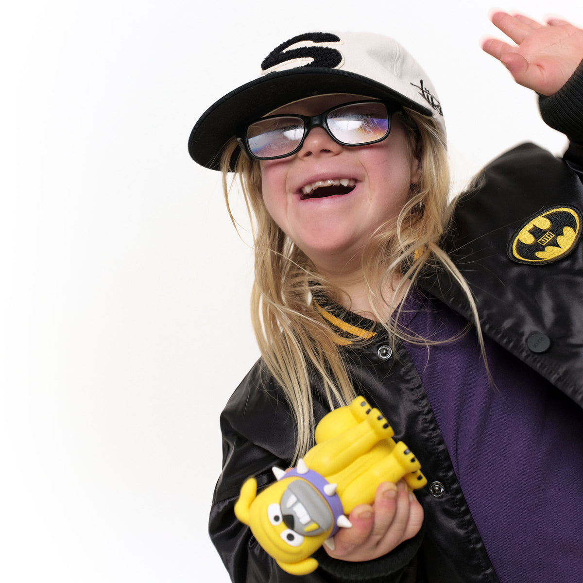 Kid in a cap holding the Tank vinyl figure